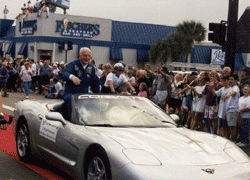 Astronaut John Glenn riding in a silver Corvette at a Parade 1990s